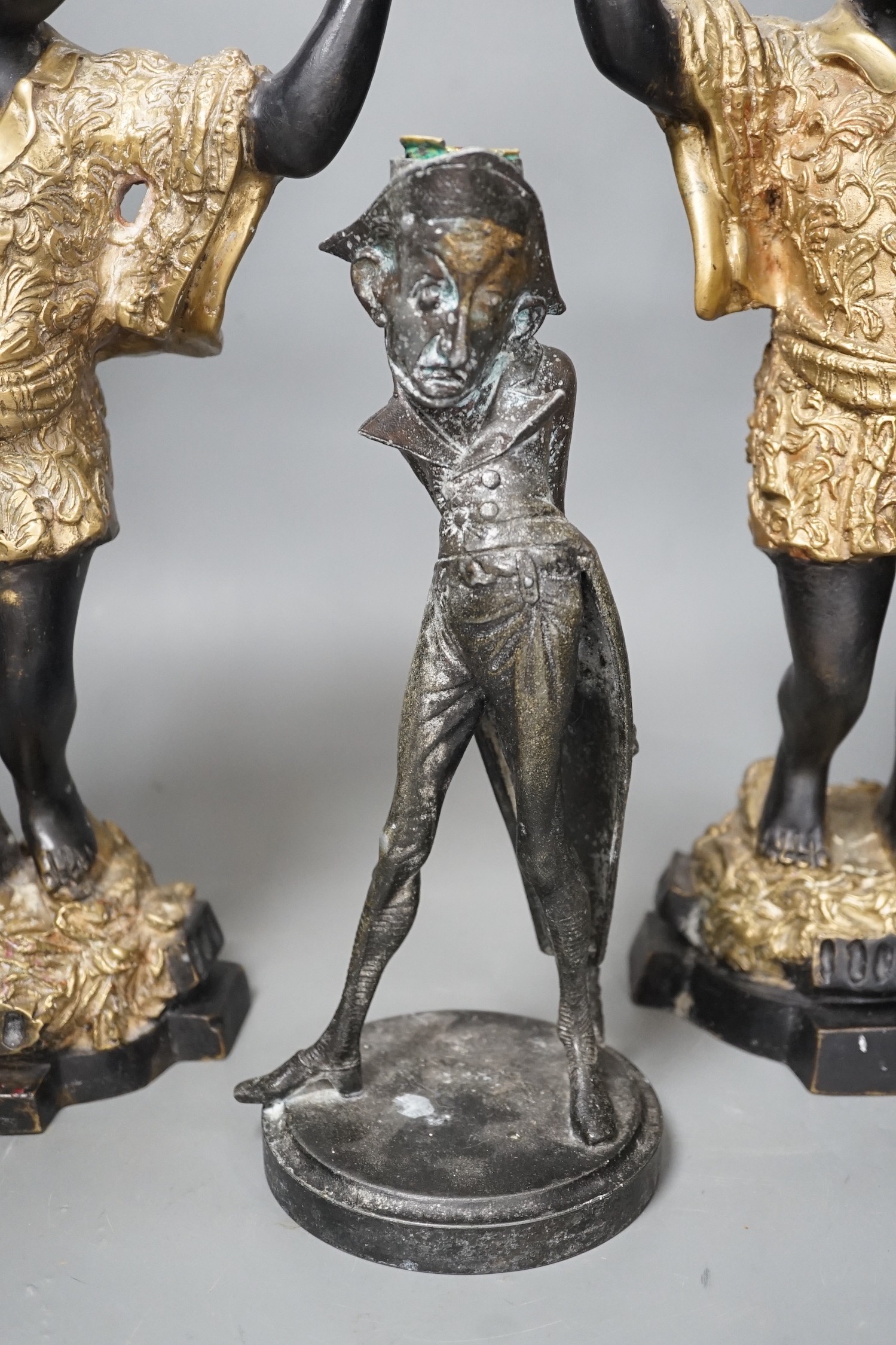 A pair of bronze blackamoor candlesticks and one other spelter figural candlestick, tallest 39cm